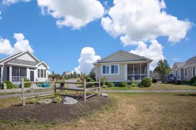 a house with a fence in front of it at The Kestrel - 2 Butternut in Cherry Valley