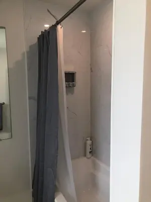 a bathroom with a shower with a shower curtain at Century Home in Bracebridge Muskoka in Bracebridge