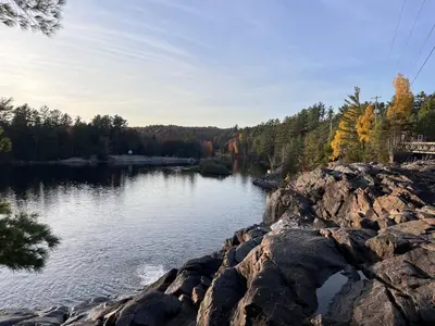 a view of a lake with rocks and trees at Century Home in Bracebridge Muskoka in Bracebridge