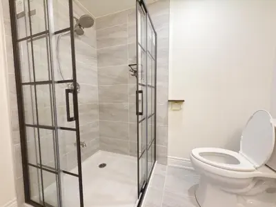 a bathroom with a shower with a toilet at Cozy room with private bath near Don Mills Subway in Toronto