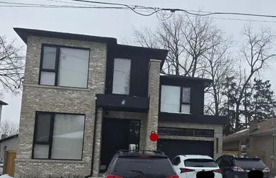 a house with cars parked in front of it at Spacious Bright 9ft Ceiling with Private Entrance in Milton