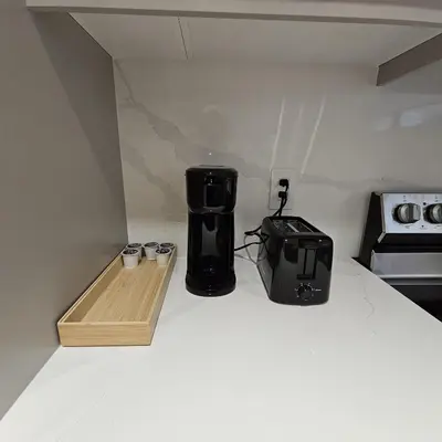 a coffee maker and a toaster sitting on a kitchen counter at Spacious Bright 9ft Ceiling with Private Entrance in Milton
