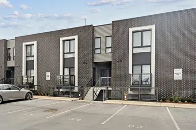 a parking lot in front of a brick building at NEW Stylish 2BR Suite With Sofa Bed, 7 Mins to Niagara Falls and Sleeps 6 in Niagara Falls