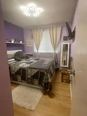 a bedroom with a bed and a window and a door at Welcoming homestay with relaxing private room in Oakville