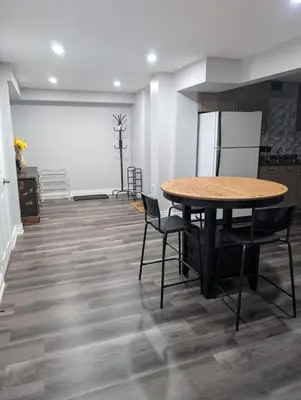 a kitchen and dining room with a table and chairs at 2 Bedroom basement Apartment in Cambridge