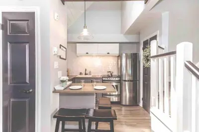 a kitchen with a table and some chairs in it at Rustic Loft at Blue in Blue Mountains