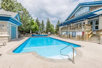 a swimming pool in front of a house at Rustic Loft at Blue in Blue Mountains