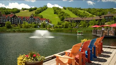 a view of a pond with chairs and a fountain at Rustic Loft at Blue in Blue Mountains