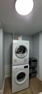 a washing machine and a washer in a room at Basement Studio in Brampton
