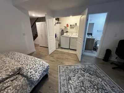 a small bedroom with a bed and a bathroom at Brand New 2 story unit in Richmond Hill