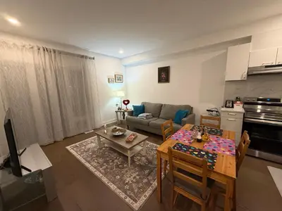 a living room with a table and a couch at Brand New 2 story unit in Richmond Hill