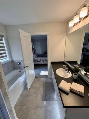 a bathroom with a tub and a sink and a shower at Whole House 4 Bedrooms 6 beds 3 bath family friendly Quite and relaxation area in Gravenhurst