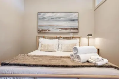 a bedroom with a bed with towels on it at MR Loft formerly The Lehman Studio Stratford in Stratford