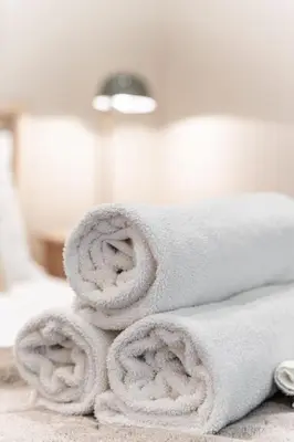 a pile of towels sitting on top of a bed at MR Loft formerly The Lehman Studio Stratford in Stratford