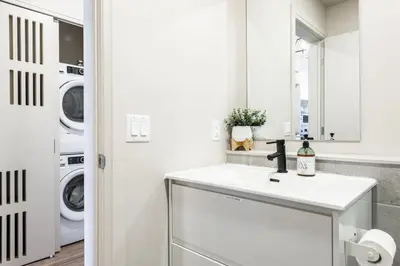a white laundry room with a sink and washing machines at MR Loft formerly The Lehman Studio Stratford in Stratford