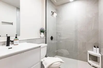 a bathroom with a shower and a toilet and a sink at MR Loft formerly The Lehman Studio Stratford in Stratford