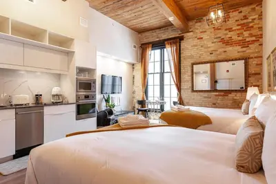 a hotel room with two beds and a kitchen at The Wallace Suite - Stratford in Stratford