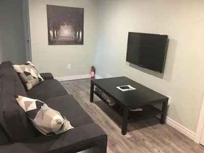 a living room with a couch and a coffee table at Splendid Modern Bungalow Suited For Big Groups in London