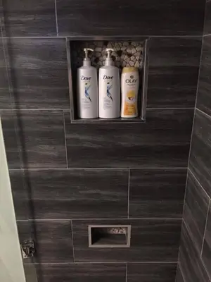 three shampoo bottles sitting on a shelf in a bathroom at Splendid Modern Bungalow Suited For Big Groups in London