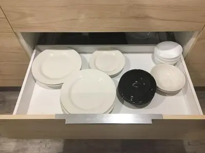 four white plates and a black bowl on a table at Upscale 2-Bedroom Basement Apartment in London