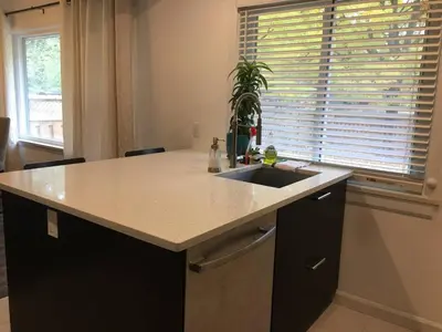 a kitchen with a sink and a counter at Comfy 3-Bedroom Home with Modern Upgrades in London