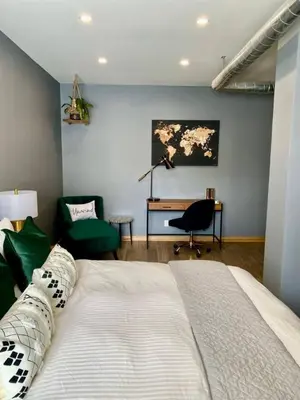 a bedroom with a bed and a desk and a chair at Stylish Modern 2 bedroom house across from Beach in Hamilton