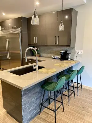 a kitchen with a sink and some green bar stools at Stylish Modern 2 bedroom house across from Beach in Hamilton