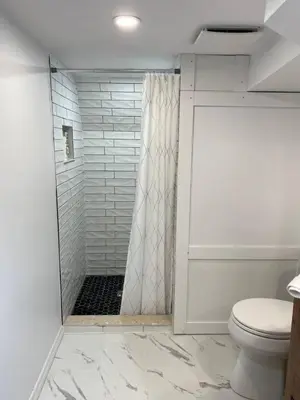 a bathroom with a shower and a toilet at Beautiful Renovated Beach Cottage Home in Hamilton