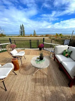 a patio with a couch and chairs and a table at Beautiful Renovated Beach Cottage Home in Hamilton
