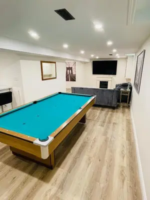 a living room with a pool table in it at Modern Thorold Apt with Pool Table in Thorold