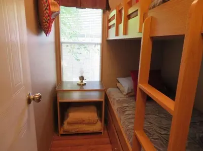 a small room with a bunk bed and a television at Westlake Dunes View Beach-FREE Pontoon Boat Rental in West Lake