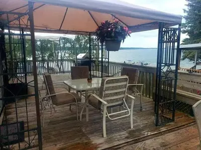 a table and chairs on a deck with a view of the ocean at Westlake Dunes View Beach-FREE Pontoon Boat Rental in West Lake