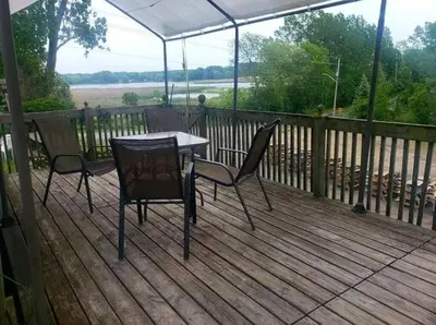 a table and two chairs on a wooden deck at Westlake Dunes View Beach-FREE Pontoon Boat Rental in West Lake