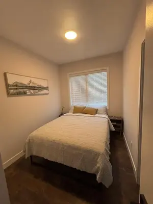 a bedroom with a bed and a window at 3 Bdrm Blue Mountain Condo in Collingwood