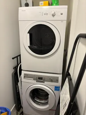 a washing machine with a microwave on top of it at 3 Bdrm Blue Mountain Condo in Collingwood