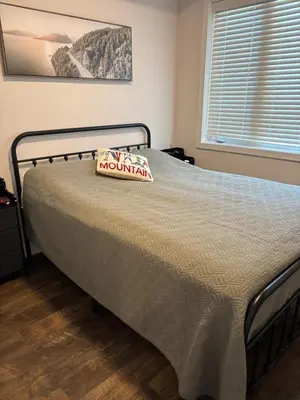 a bedroom with a bed with a mountain sign on it at 3 Bdrm Blue Mountain Condo in Collingwood