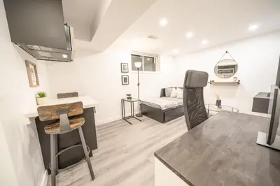 a living room with a desk and a couch at Luxurious 2 Bed Apartment in Downtown Cambridge in Cambridge