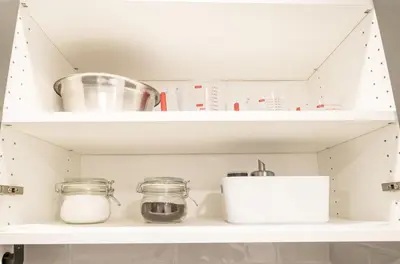 a kitchen shelf with jars and utensils at Luxurious 2 Bed Apartment in Downtown Cambridge in Cambridge