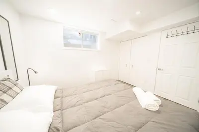 a bedroom with a large bed and a white door at Luxurious 2 Bed Apartment in Downtown Cambridge in Cambridge