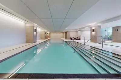 a large swimming pool in a building at Condo in Yorkville - Newly Furnished Luxury Unit in Toronto