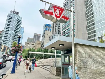 a sign for a store on a city street at Condo in Yorkville - Newly Furnished Luxury Unit in Toronto