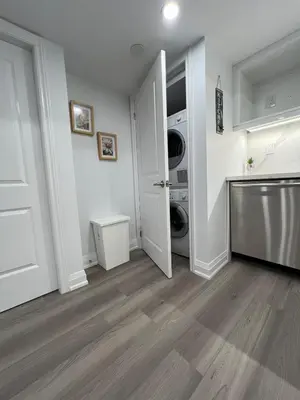 a laundry room with a washer and dryer at Cozy 2 Bedrooms Modern Basement Suite with Private entrance, Kitchen and parking in Mississauga
