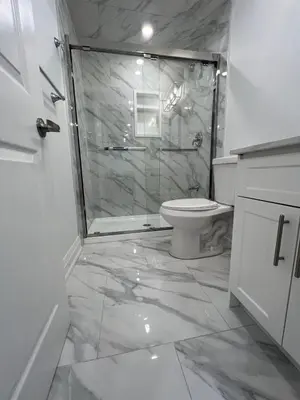 a bathroom with a shower and a toilet at Cozy 2 Bedrooms Modern Basement Suite with Private entrance, Kitchen and parking in Mississauga