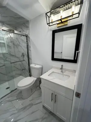 a bathroom with a toilet and a sink and a shower at Cozy 2 Bedrooms Modern Basement Suite with Private entrance, Kitchen and parking in Mississauga