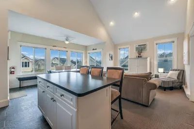 a kitchen with a large island in a living room at The Meadowlark - 115 Butternut in Cherry Valley