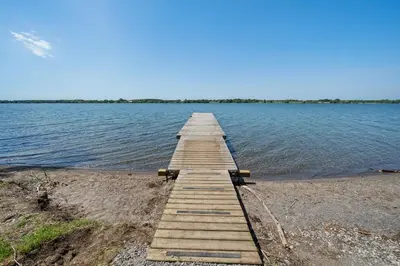 a wooden pier on the shore of a lake at The Meadowlark - 115 Butternut in Cherry Valley