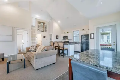 a kitchen and living room with a couch and a table at The Meadowlark - 115 Butternut in Cherry Valley