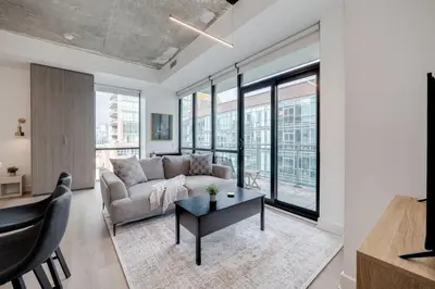 a living room with a couch and a table at Studio Gem in the lovely Waterfront Communities in Toronto