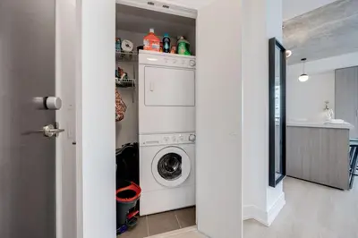 a laundry room with a washer and dryer at Studio Gem in the lovely Waterfront Communities in Toronto