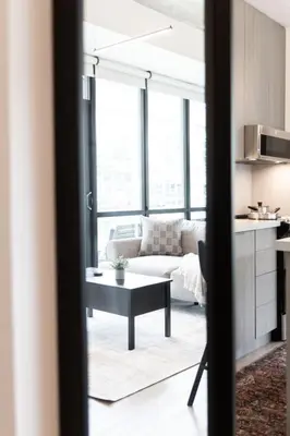 a living room with a couch and a table at Studio Gem in the lovely Waterfront Communities in Toronto
